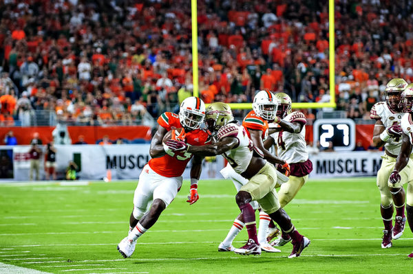 Hurricanes TE, Christopher Herndon, tries to elude the tackle from a FSU defender
