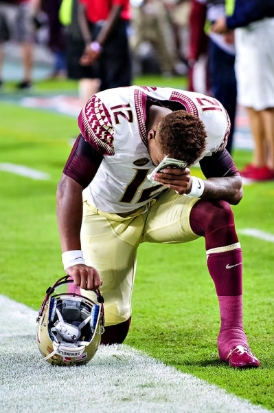Florida State QB, Deondre Francois, prays before the game