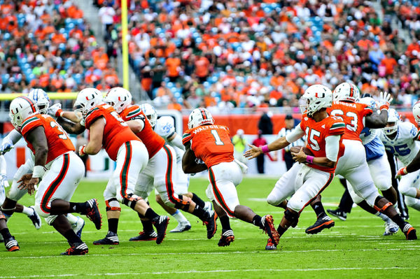 Hurricanes QB, Brad Kaaya, fakes a handoff to Mark Walton