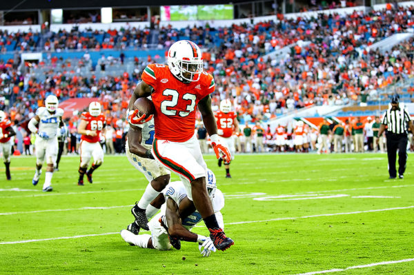Hurricanes TE, Christopher Herndon, breaks a tackle as he heads up field after a catch