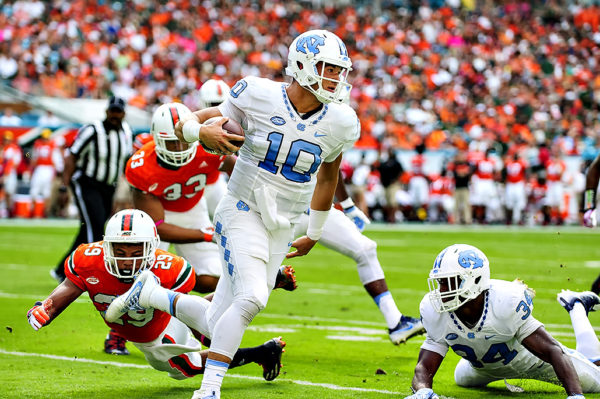 North Carolina QB, Mitch Trubisky, eludes the tackle of Corn Elder