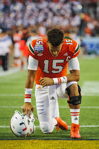 Brad Kaaya, Miami Hurricanes QB, prays before the start of the Russell Athletic Bowl
