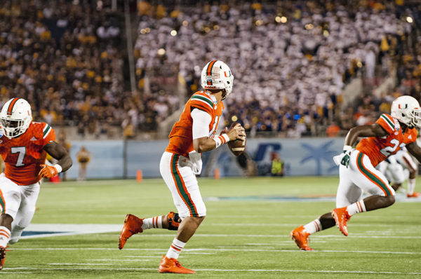 Brad Kaaya looks downfield as he scrambles out of the pocket