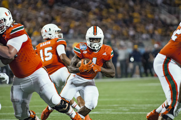 Miami Hurricanes RB, Mark Walton, looks for an opening to run through