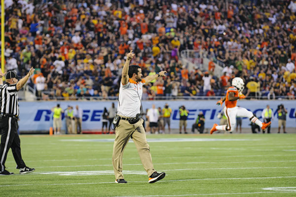 Miami Hurricanes defensive coordinator, Manny Diaz, celebrates the team's fumble recovery