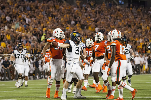 Sklyer Howard, West Virginia QB, signals a first down