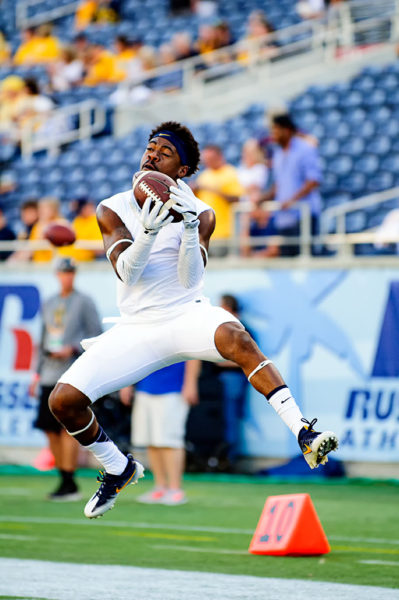West Virginia players warm up prior to the game