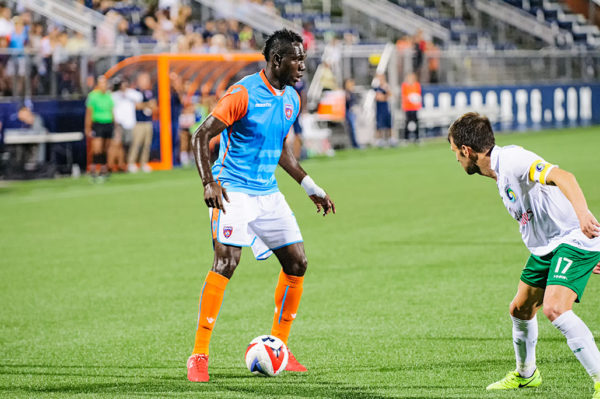 Miami FC midfielder, Kwadwo Poku, tires to dribble past a defender