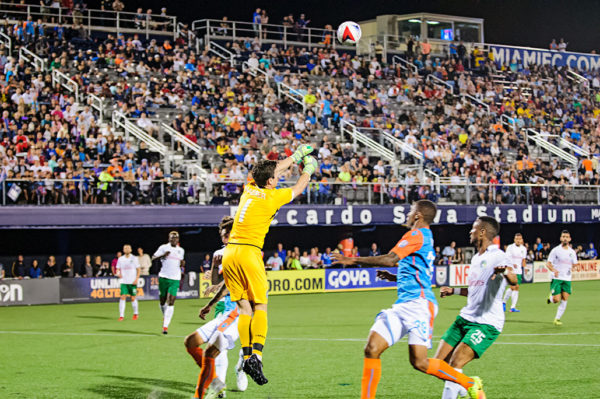 New York Cosmos goalie, Jimmy Maurer, punches the ball away