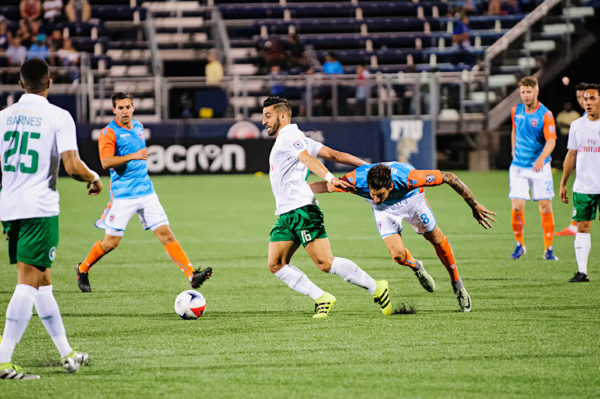 New York Cosmos midfielder, Juan Guerra, tries to keep the ball away from Vincenzo Rennella