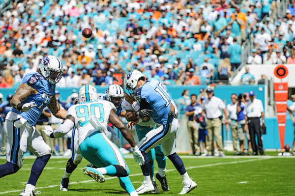 Cameron Wake hits Titans QB, Matt Cassel, as he throws a pass