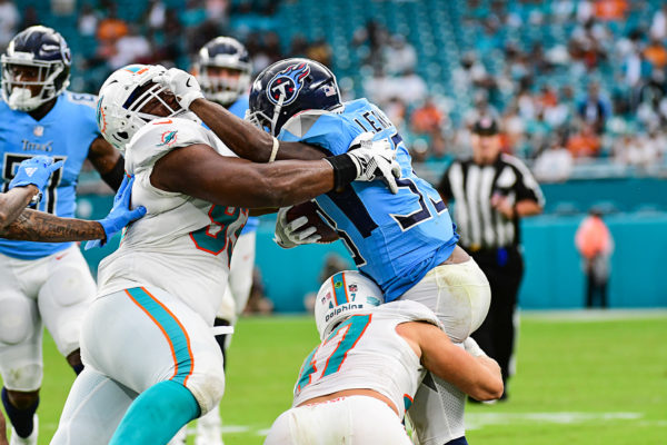 Tennessee Titans running back Dion Lewis (33) tries a stiff arm as he is being tackled