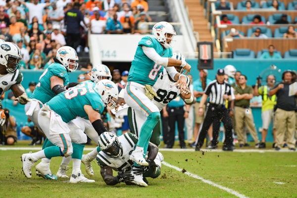 Miami Dolphins quarterback Brock Osweiler (8) throws under pressure