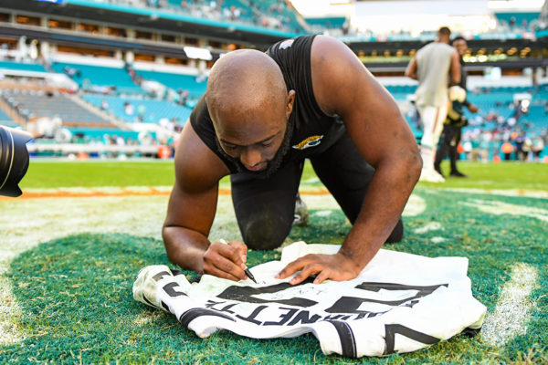 Jacksonville Jaguars running back Leonard Fournette (27) signs his jersey